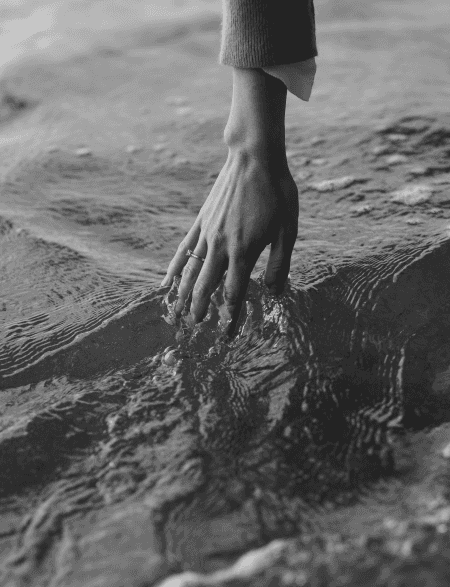 Hand touching water